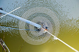 A submersible garden pump immersed in a pond. Pumping water for irrigation