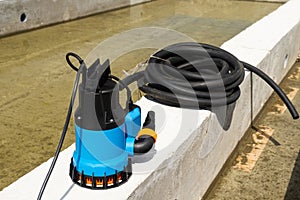 Submersible pump dewater construction site, pumping flood water sing deep well.