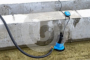 Submersible pump dewater construction site, pumping flood water sing deep well.