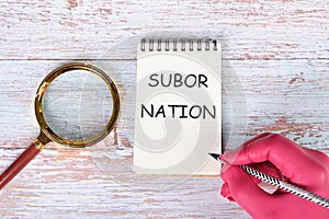 Subornation text written with pencil on paper notebook