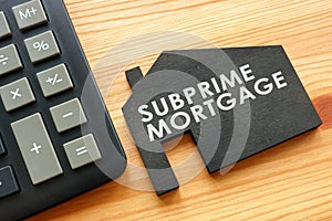 Subprime mortgage on the model of home and calculator.