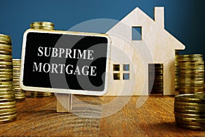 Subprime mortgage plate and model of home photo
