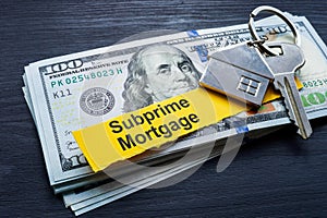 Subprime mortgage. Stack of cash and key. photo