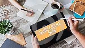 Subscribe button on device screen. Internet and digital marketing concept.