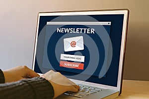 Subscribe newsletter concept on laptop computer screen on wooden