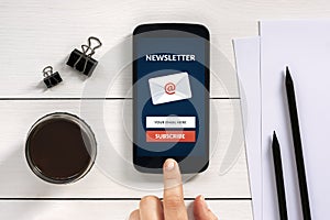 Subscribe newsletter concept on smart phone screen with office o