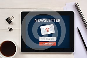 Subscribe newsletter concept on tablet screen with office object