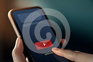 Subscribing and Digital Marketing Concept. Closeup of Woman using Smartphone to making Subscribe on a Favorite Channel photo
