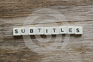 Subtitles alphabet square on wooden background