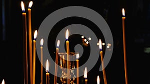 Subtle church candles burn in an Orthodox Christian