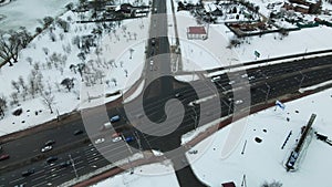 Suburb of a big city. City block from the height of the flight. City highway with busy traffic. Winter cityscape. Aerial photograp
