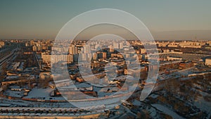 Suburb of a big city. City block from the height of the flight. City highway with busy traffic. Winter cityscape. Aerial photograp