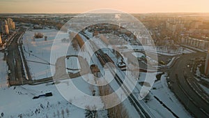 Suburb of a big city. City block from the height of the flight. City highway with busy traffic. Winter cityscape. Aerial photograp