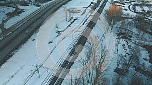 Suburb of a big city. City block from the height of the flight. City highway with busy traffic. Winter cityscape. Aerial photograp