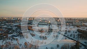 Suburb of a big city. City block from the height of the flight. City highway with busy traffic. Winter cityscape. Aerial photograp