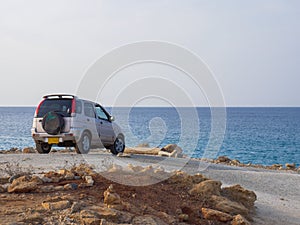 Suburban four-by-four car chiling at the coastline