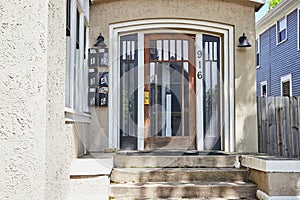 Suburban Home Entrance with Wooden Door and Mailbox, Eye-Level View