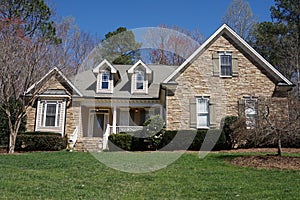 Suburban house with stone exterior in an affluent neighborhood photo
