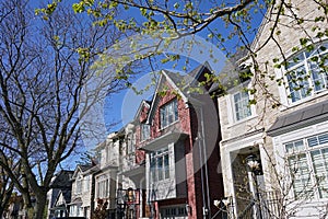 Suburban houses with traditional architecture with gables and stone front