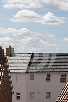 Suburban housing. Modern white house building with slate roof ti