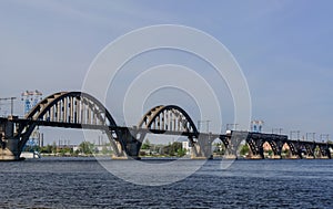 Suburban passenger train on the Merefa-Kherson bridge across the Dnieper River.