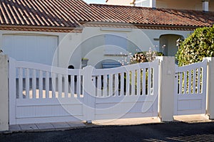 Suburban pvc plastic gate white fence on home suburb street access house garden