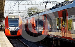 Suburban trains arrive at the railway platform