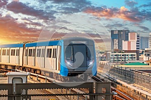 Subway modern high speed commuter train colorful sunset cityscape
