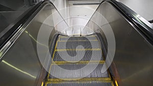 Subway station escalator moving up. Top view. Big city underground metro