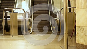 Subway station and moving up and down escalator. Media. Empty mechanical stairs of the underground station, concept of