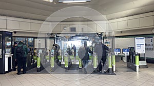 Subway Station Platform with Passengers and Turnstiles