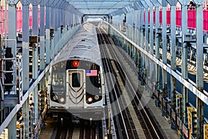 Subway train traveling on tracks across the Williamsburg Bridge from Brooklyn to Manhattan in New York City NYC