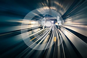 Subway tunnel with blurred light tracks with arriving train