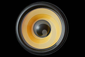 Subwoofer dynamic membrane or sound speaker isolated on black background, yellow Hi-Fi loudspeaker close up