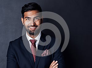 Succeeding in business with confidence and conviction. Studio shot of a confident young businessman posing against a