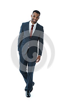 Succeeding with style. A handsome young african american businessman walking while isolated on white.