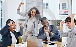 Succeeding in their mission as a team. a group of businesspeople cheering in an office.