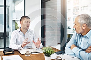 Succeeding in todays competitive market requires smart strategies. Shot two businessmen having a meeting in a modern