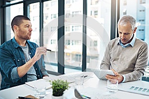 Success in action. Shot two businessmen having a meeting in a modern office.