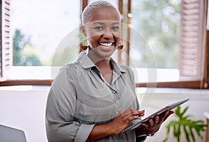 Success is all I see in my forecasts. Portrait of a young businesswoman using a digital tablet in an office.