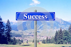 Success on blue street sign with landscape