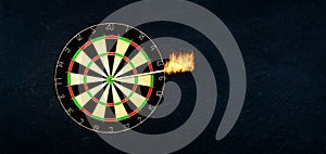 Success and business concept: Dartboard with burning arrow in the bulls eye or the target.
