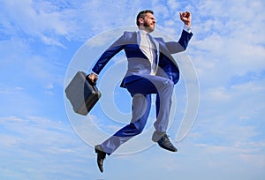 Success in business demands supernatural efforts. Businessman with briefcase jump high in motion forward. Supernatural
