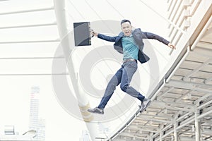 Success Business man jumping in the air. Happy businessman movement with cheerful