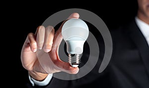 Success businessman hold lightbulb for success business creative thinking idea concept with suit during work in office and