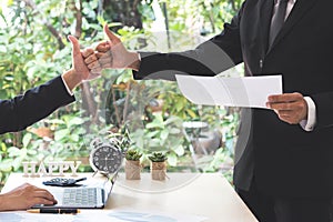 Success businessman partners making fist bump and thump up showing trust in team in office with laptop, document, calculator and