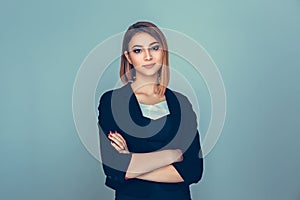 Success. Closeup portrait head shot confident beautiful happy young woman arms crossed smiling isolated green blue background.