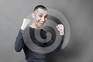 Success concept for excited 30s man with hands up for fun photo