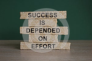 Success and effort symbol. Concept words Success is dependent on effort on brick block.