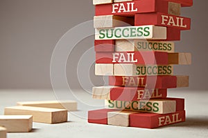 Success and fail. Wooden tower of blocks. Failure is like new step for success. Failure gives experience and makes you successful photo